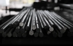 Stacked round steel bar stock with cut ends facing the camera, the raw material used to make industrial slitting knives