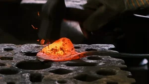 Red hot steel forging during industrial blade heat treatment